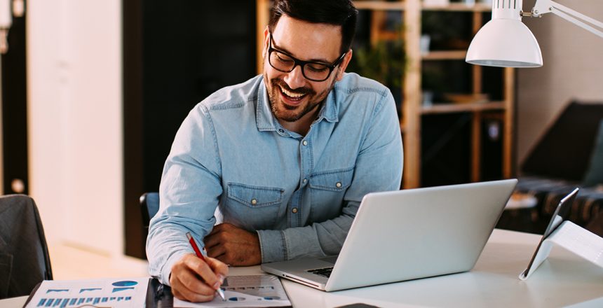 Young,Business,Man,Working,At,Home,With,Laptop,And,Papers